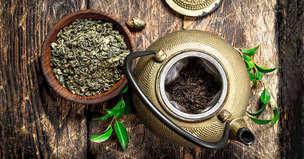 green_tea_leaves_teapot_scene Green tea leaves with teapot, symbolizing Synergy Health’s natural and wellness-oriented services offered.